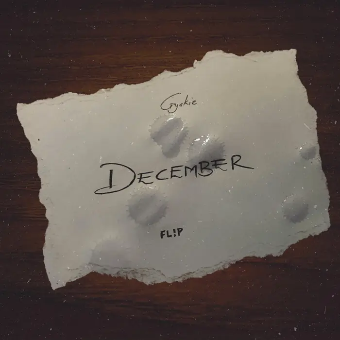 A torn white sheet of paper with drops of tears on it with an inscription 'Gyakie December'.The artwork for "Gyakie - December"